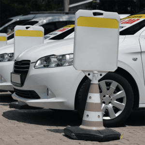 a row of white cars parked in a parking lot.