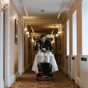 a man pushing a cart down a hallway.