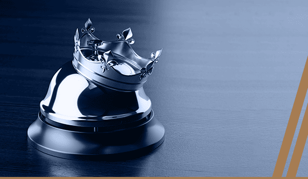 Silver concierge desk bell with a crown, symbolizing premium hospitality service